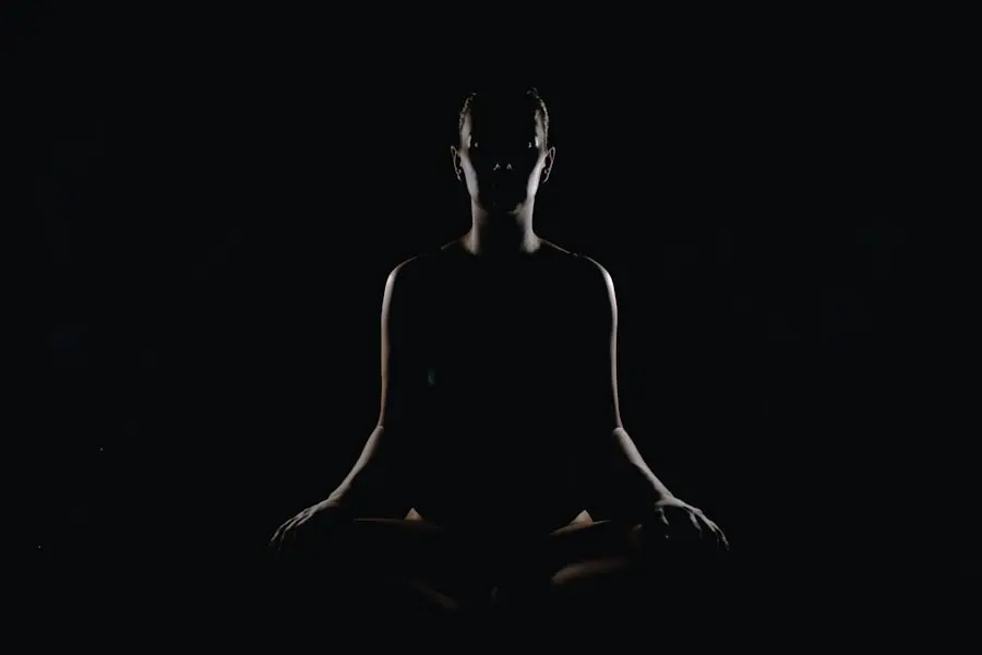 A person seated in a calm breathing practice, eyes closed, quiet and still
