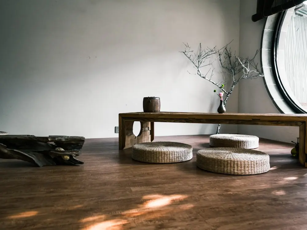Magazine spread placeholder, a wooden bench beside a bright window with plants and warm light