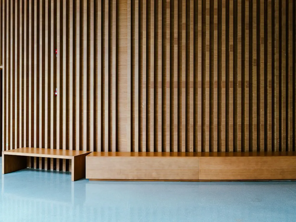 Magazine spread placeholder, the warm wooden studio interior with a slatted wall, soft daylight