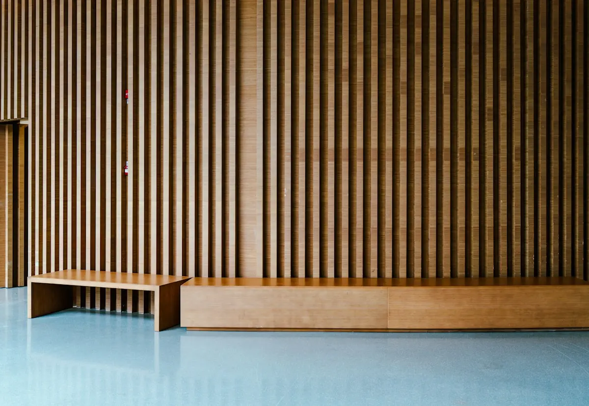 The studio room from the doorway, warm wood and big windows, soft morning light