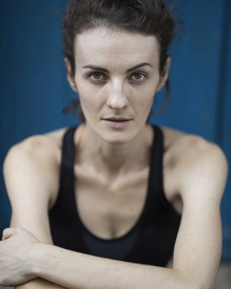 Portrait of Maya, a calm woman in a black top, soft daylight, warm and approachable